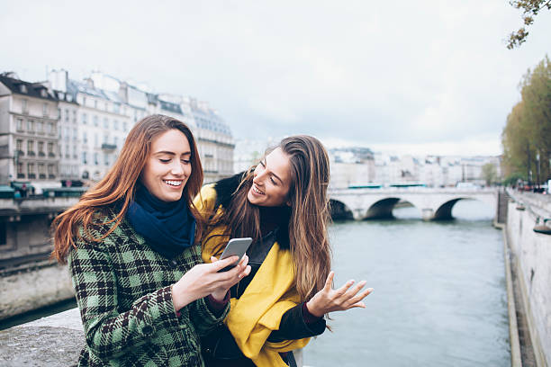 istock Two smiling women walking on bridge 603155722