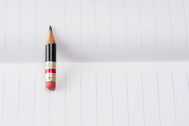istock Black pencil with pink eraser on a paper 603155984