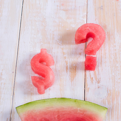 Watermelon in the form of dollar and question mark. Slice of watermelon money