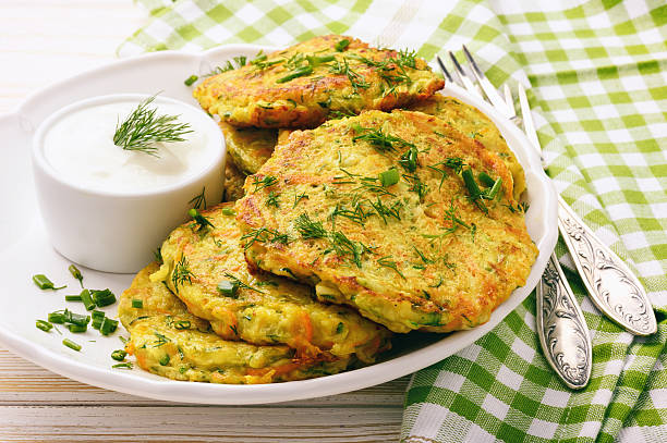 istock Fritters with zucchini and carrots on white wooden background. 603158592