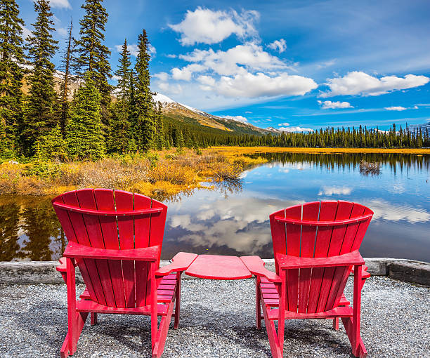 istock Two red  chairs on the lake 603161638