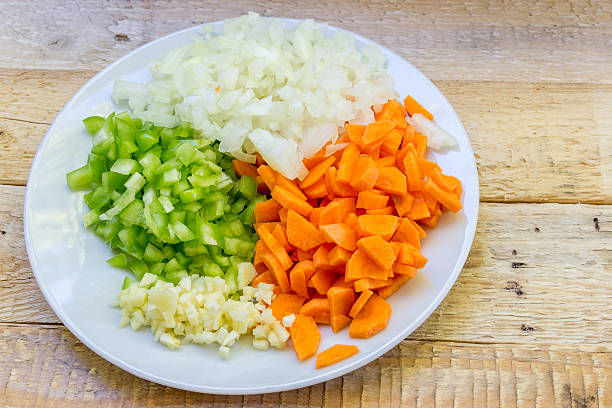 istock White plate with chopped vegetables on a wooden rough background 603163140