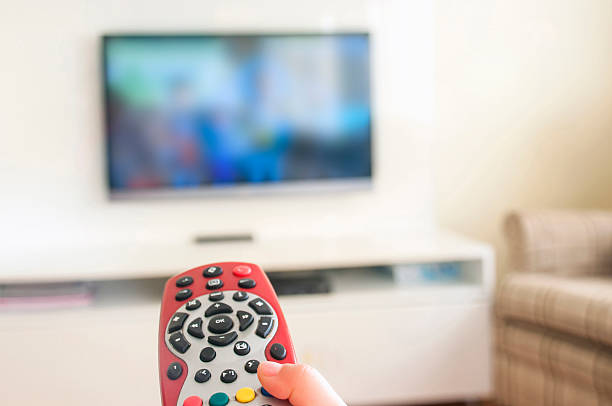 istock Watching animated cartoon on  TV remote control in hand 603166352