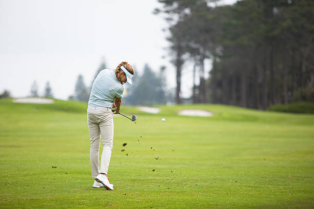 istock Young female golfer shoots for the green 603167954