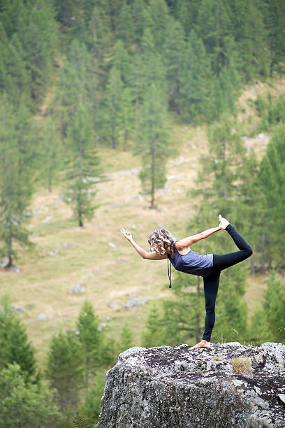 istock Yoga exercises in nature: Dancer pose 603170364