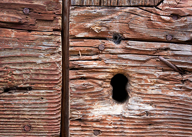 istock Keyhole on a dry wooden door 603173606