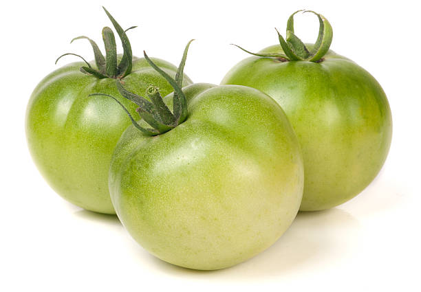 istock Three green unripe tomato isolated on white background 603174690