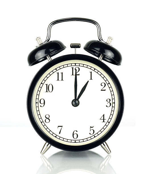 istock Alarm Clock isolated on white, showing one o'clock. 603174874