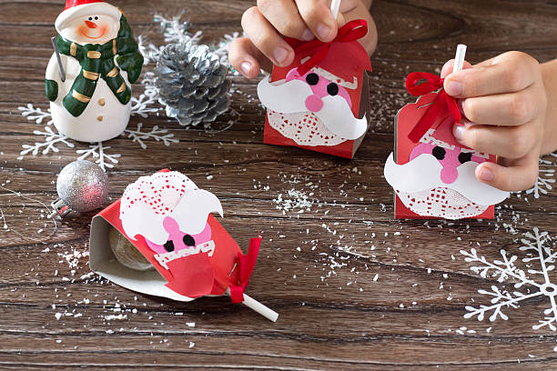 istock The child create a greeting packaging for candy Santa Claus 603175834