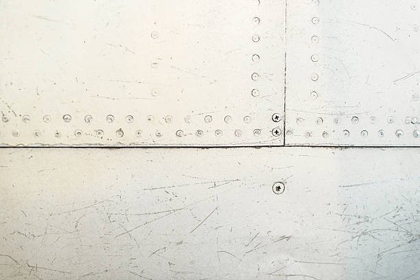 paint scrapes and weathering on airplane panel with rivets. - old airplane macro horizontal imagens e fotografias de stock