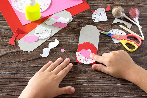 istock The child create a greeting packaging for candy Santa Claus 603176074
