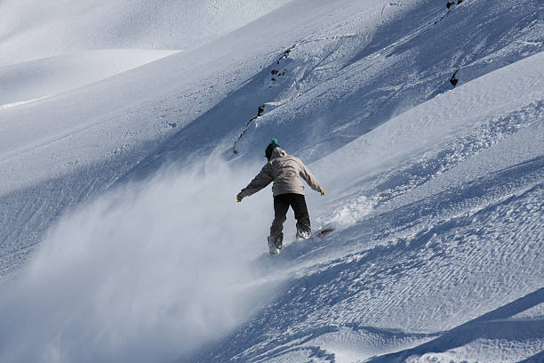 Young man in mid-air making snowboard  jump.