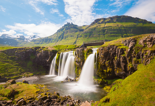 Kirkjufellsfoss waterfall in summertime surrounded by green