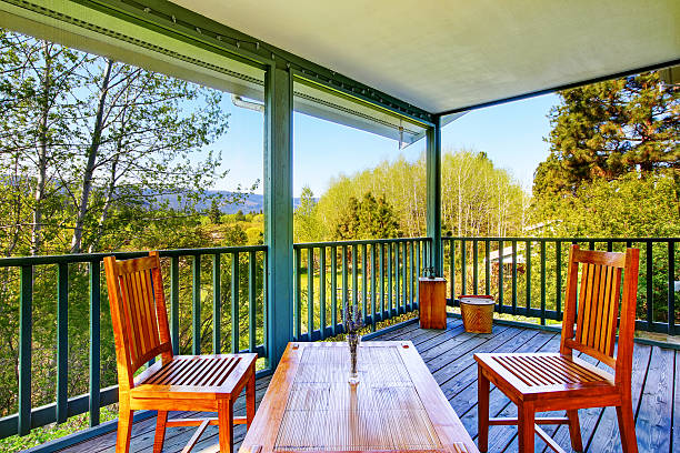 istock Covered porch with wooden table setting 603178814