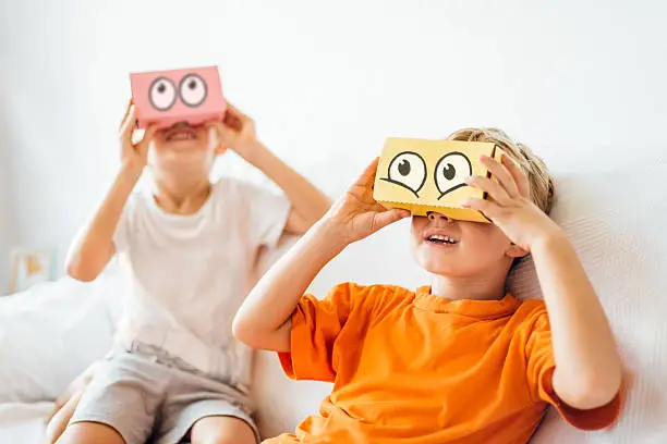 Photo of Children playing with Virtual Reality Headsets