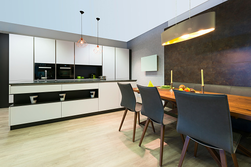 modern elegant white flat kitchen with island and dining table