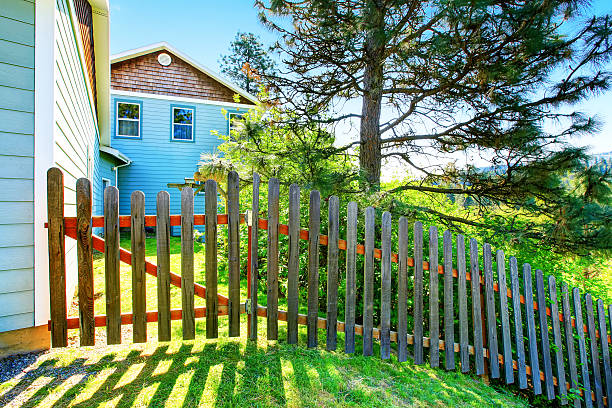 istock County style long wooden fence with gate. 603180176