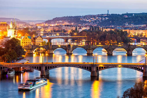 elevated view of bridges on Vltava river illuminated at twilight, in the center (the second one) is visible the famous Charles Bridge, Prague, Czech Republic