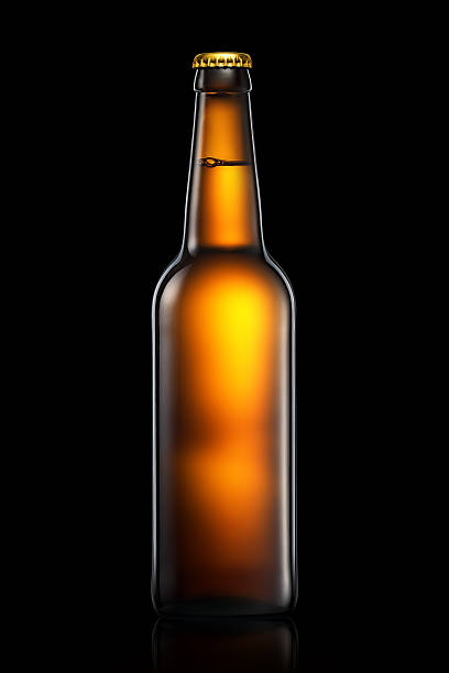 istock Bottle of beer or cider isolated on black background 603180924