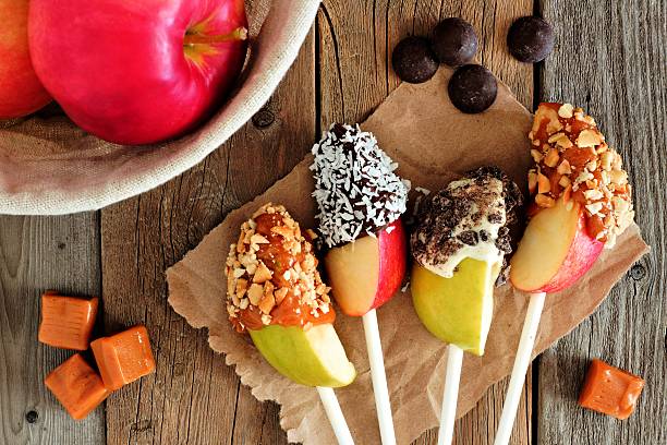 istock Chocolate and caramel dipped apple slices, scene on rustic wood 603181484