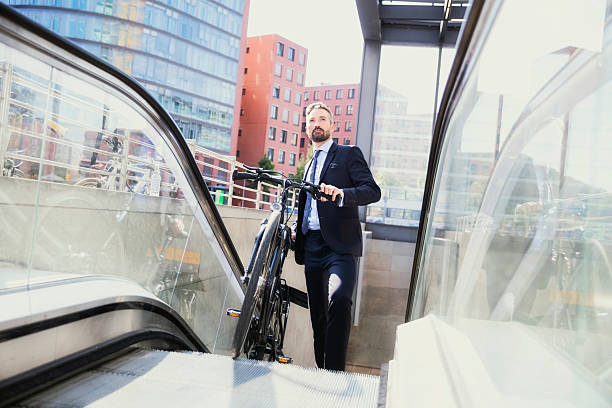 istock Businessman with bicycle moving on escalator 603181746