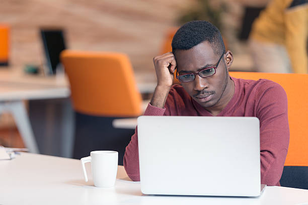 istock Handsome successful African American looking at the screen 603181770