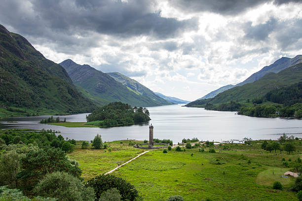 Scotland Glenfinnan monument at Loch Shiel Scotland Glenfinnan monument in dramatic sky and Highlands mountain landscape Loch Shiel glenfinnan monument stock pictures, royalty-free photos & images