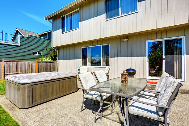 istock Backyard concrete floor patio area with hot tub. 603182508