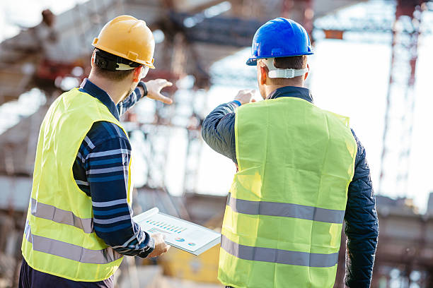 Engineer and contractor having brief meeting on construction site