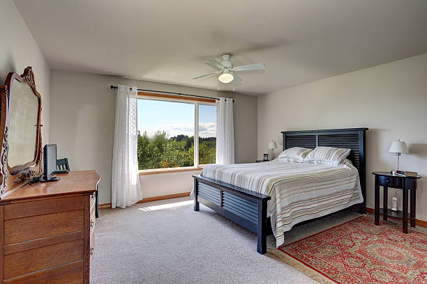istock Bedroom interior with beige walls, rug and white curtains 603182964