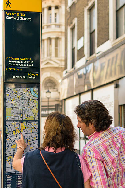 Tourists check London map stock photo