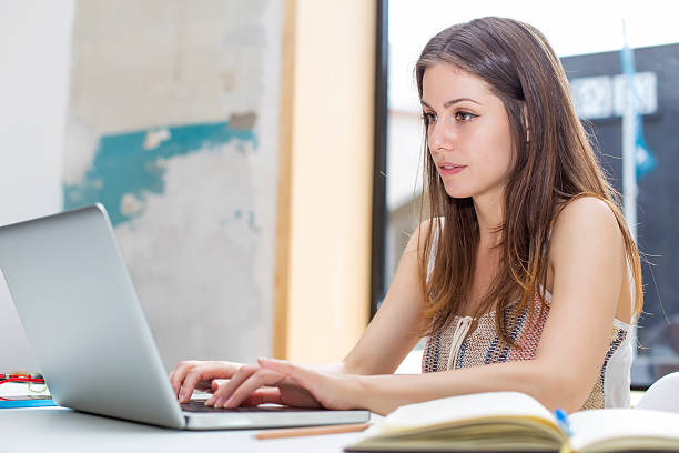 istock Young woman with laptop 603184448