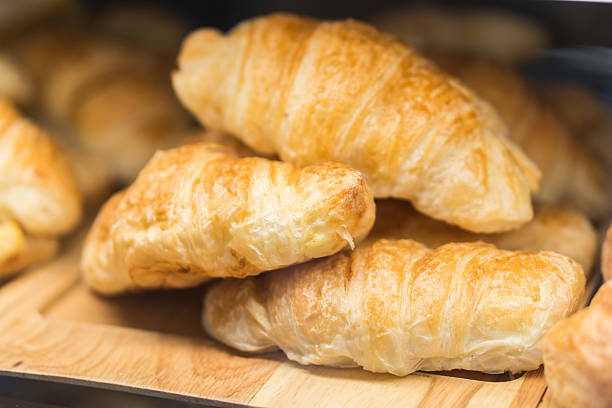 istock Tasty croissants on grey wooden background 603184692