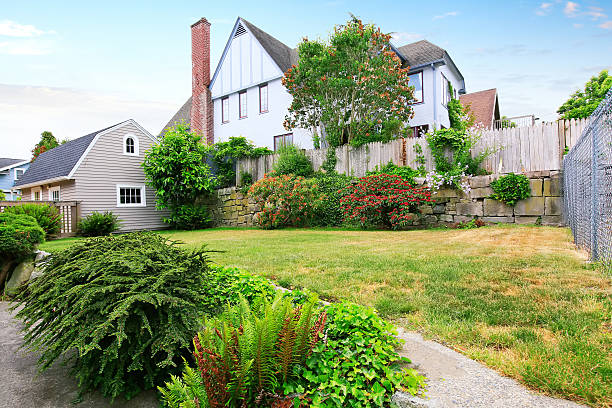 istock Back yard house exterior with well kept garden around. 603184814