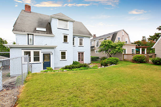 istock Back yard house exterior with well kept garden around. 603184926