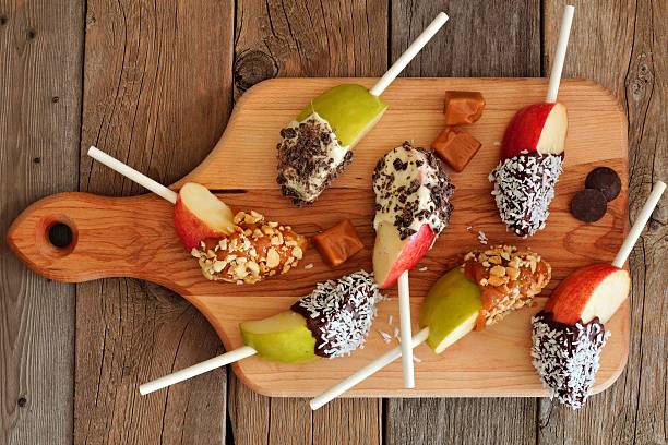 istock Caramel and chocolate dipped apple slices on a paddle board 603185380