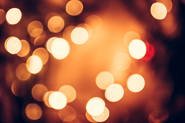 istock Christmas background with orange bokeh from candle lights 603185644