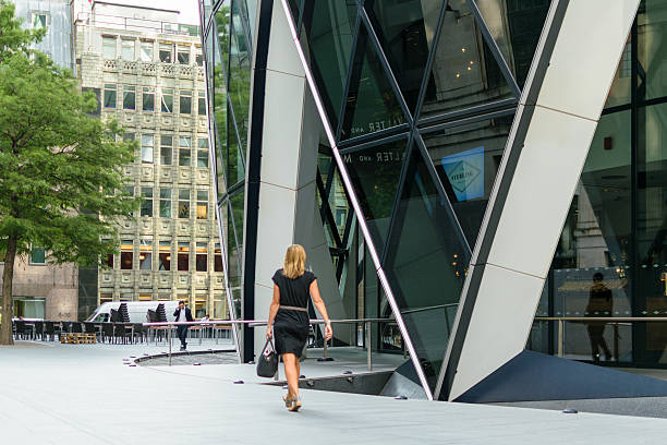 Woman walks pass business building stock photo
