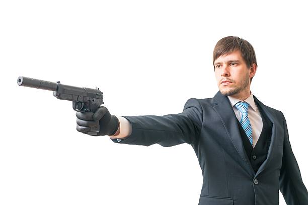 istock Secret agent is aiming with pistol with silencer. 603186724