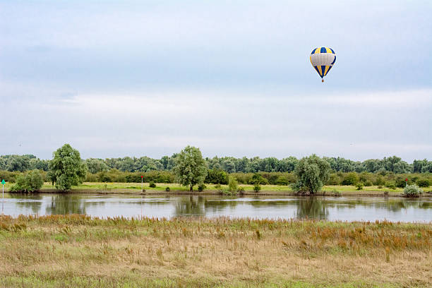 Golden sunlight on a summer morning cast over a scenic rural landscape with tourist hot air balloons in the Hunter Valley region, renowned wine country in NSW, Australia.