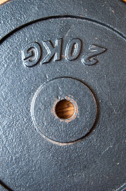 istock 20 kg. Weight on a wooden backgound. 603188936