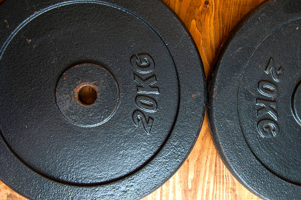 istock 20 kg. Weight on a wooden backgound. 603189142