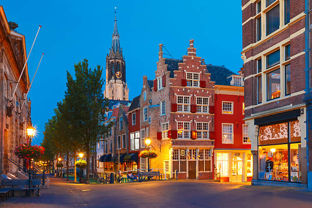 Night canal, typical dutch house and Gothic Protestant Nieuwe Kerk, New church, in Delft, Holland, Netherlands
