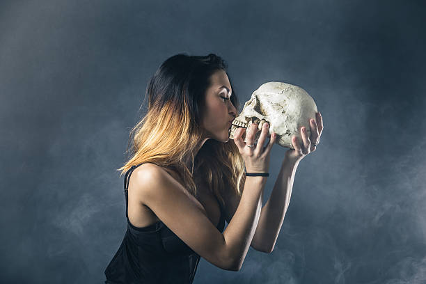 istock Woman kissing skull 603189854