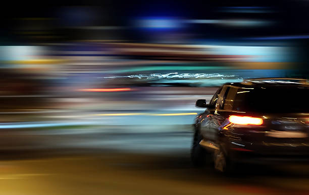 istock Car rides through the night city 603192702