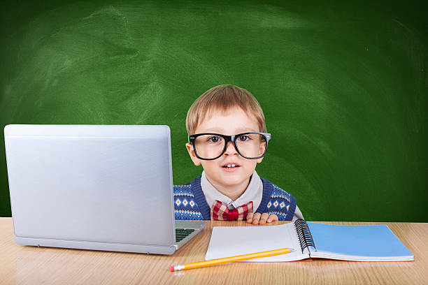 istock Child with laptop peeking in the classroom 603193294