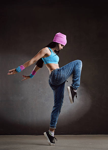 istock Young sexy woman dancer dancing on wall background 603193370