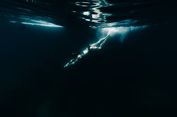 istock Woman diving into dark water 603195900