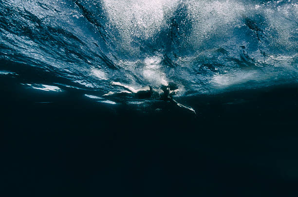 istock Woman swimming across deep dark water underwater 603195932