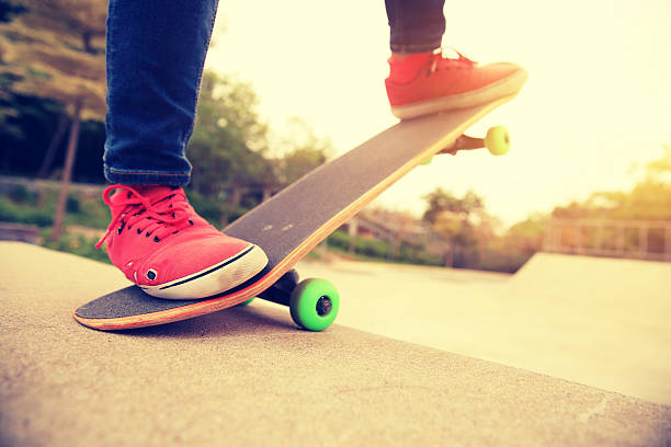 istock skateboarding legs at skatepark ramp 603198314